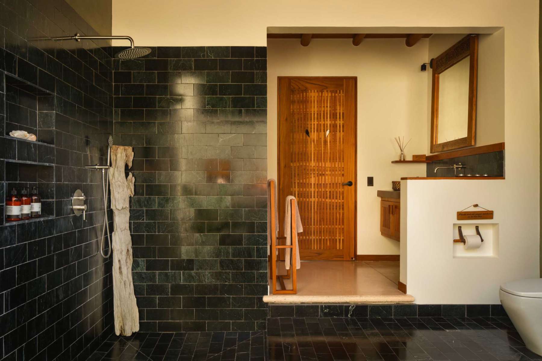 Stone-tiled bathroom and rain shower